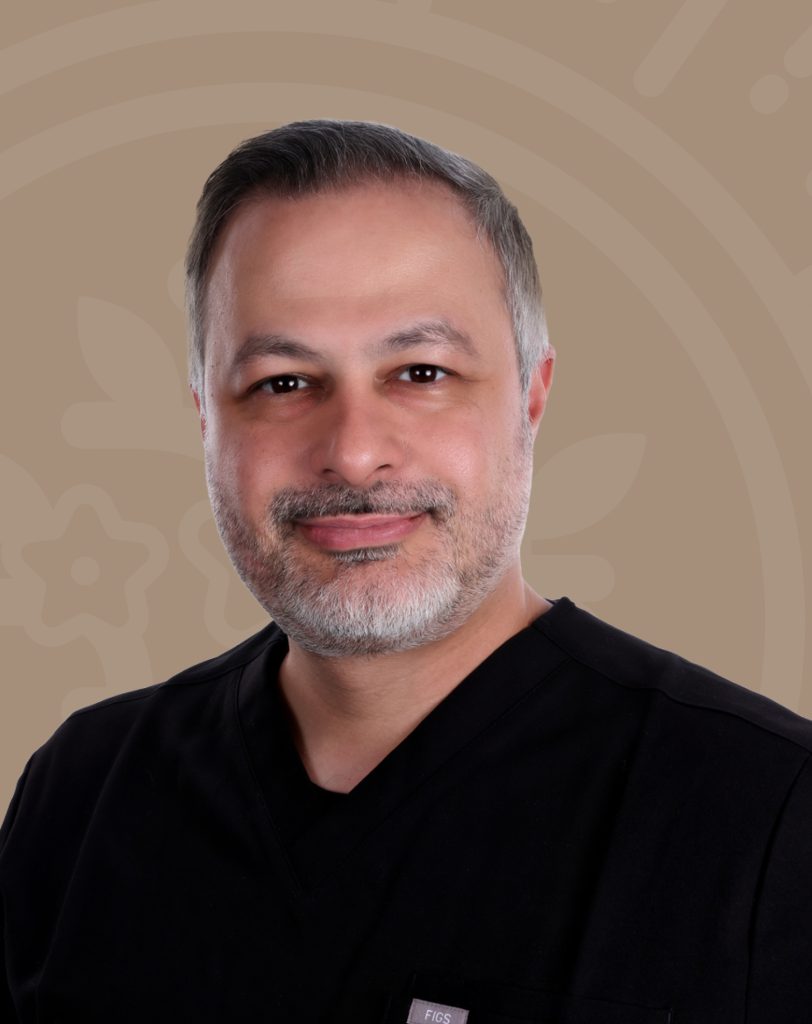 Dr. Amin Esfahani, MD, smiling in black scrubs