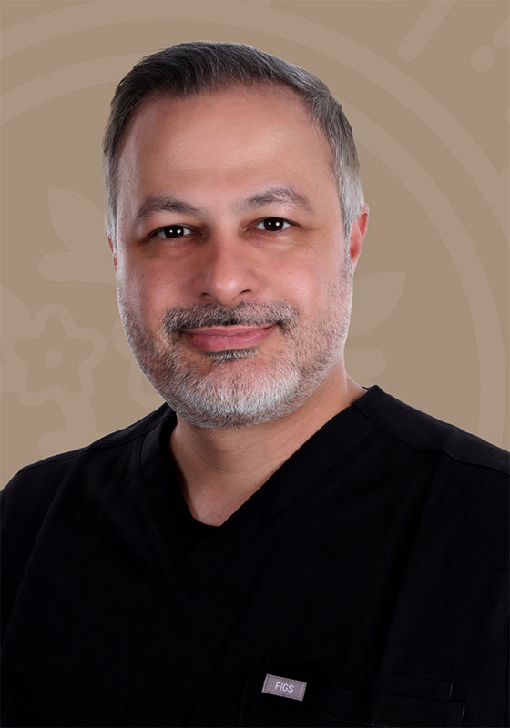 Dr. Amin Esfahani, MD, smiling in black scrubs
