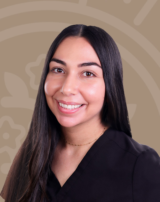 Azsha Samando, NP, smiling in black scrubs